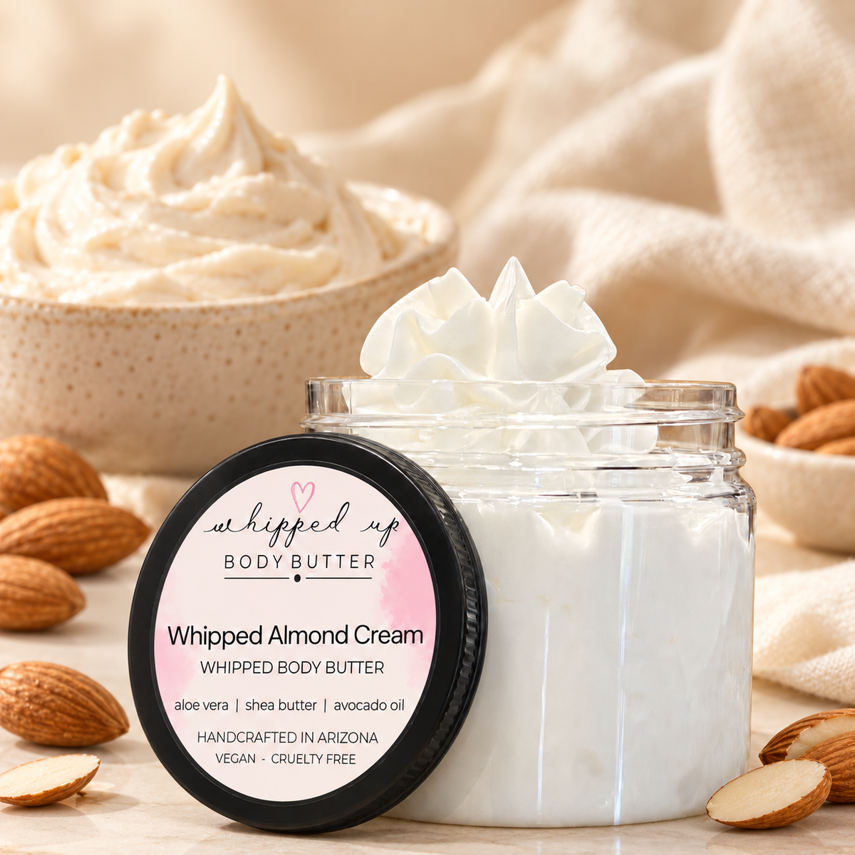 Creamy whipped almond body butter in a jar, showcasing smooth texture and rich almond scent for nourishing skincare.